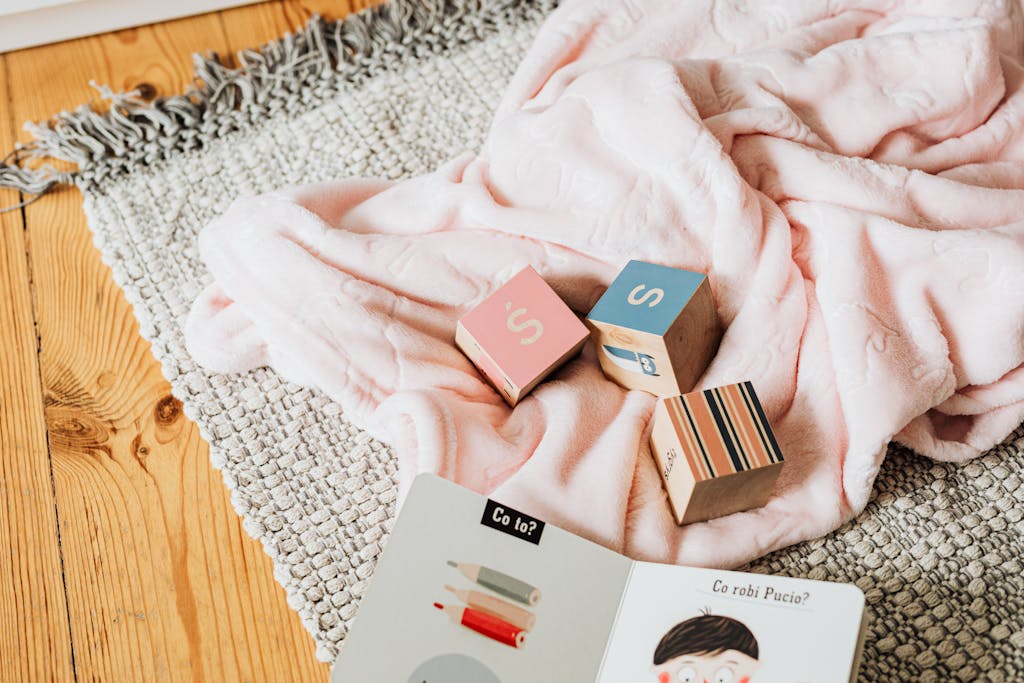 A cozy setup with educational blocks and a children's book on a woven rug.