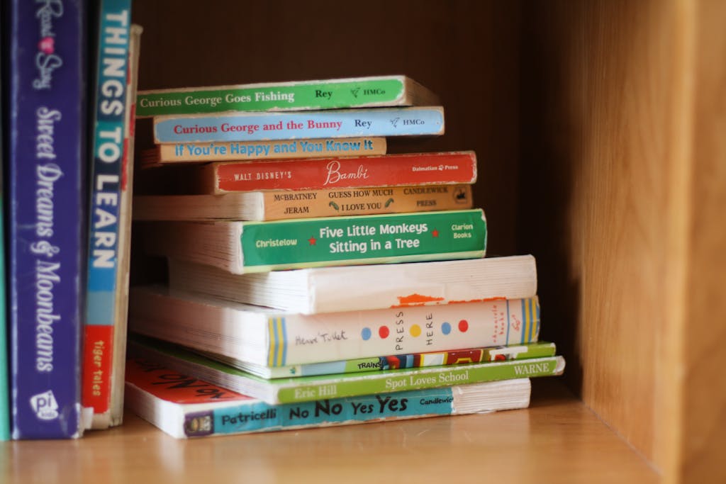 Colorful arrangement of children's books on a wooden shelf, showcasing popular titles.